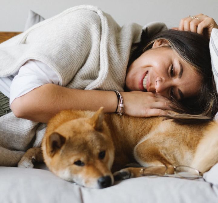 Woman laying with her dog.